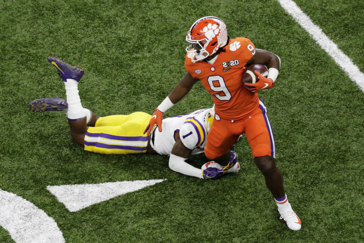 Clemson running back Travis Etienne is tackled by LSU cornerback Kristian Fulton during the first half of a NCAA College Football Playoff national championship game Monday, Jan. 13, 2020, in New Orleans. (AP Photo/Eric Gay)