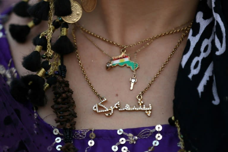 A woman wears a necklace bearing the Kurdish flag as she takes part in a gathering to urge people to vote in the upcoming independence referendum for Iraqi Kurdistan, which has faced mounting opposition from Baghdad and abroad including Iran