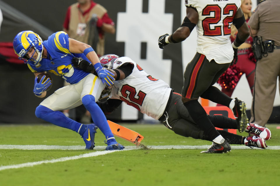 Los Angeles Rams wide receiver Cooper Kupp (10) is tackled by Tampa Bay Buccaneers safety Mike Edwards (32) after scoring a 69-yard touchdown reception during the first half of an NFL football game between the Los Angeles Rams and Tampa Bay Buccaneers, Sunday, Nov. 6, 2022, in Tampa, Fla. (AP Photo/Chris O'Meara)