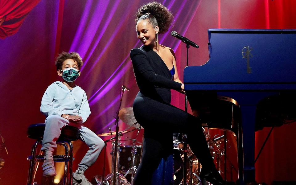 Keys performs next to her son, Genesis Ali Dean, at the Apollo Theatre in New York - Getty