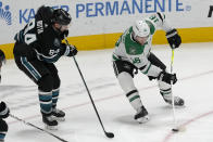 Dallas Stars center Joe Pavelski (16) skates with the puck against San Jose Sharks defenseman Jan Rutta (84) during the third period of an NHL hockey game in San Jose, Calif., Tuesday, March 26, 2024. (AP Photo/Jeff Chiu)