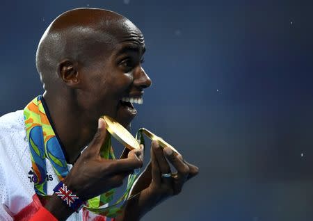 2016 Rio Olympics - Athletics - Victory Ceremony - Men's 5000m Victory Ceremony - Olympic Stadium - Rio de Janeiro, Brazil - 20/08/2016. Mo Farah (GBR) of Britain poses with his medals. REUTERS/Dylan Martinez