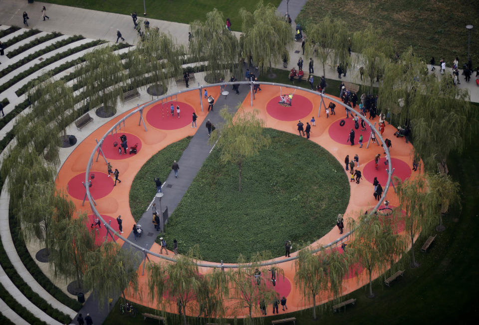 In this picture taken on Saturday, Oct. 27, 2018 a view of the 'Tree Library' park, in Milan, Italy. If Italy's fashion capital has a predominant color, it is gray not only because of the blocks of uninterrupted neoclassical stone buildings for which the city is celebrated, but also due to the often-gray sky that traps in pollution. The city has ambitious plans to plant 3 million new trees by 2030_ a move that experts say could offer relief to the city’s muggy and sometimes tropical weather. (AP Photo/Luca Bruno)