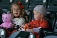 Braxton Moore, 4, and his sister Madison, 6, of Sacramento, Calif., watch batting practice before the start of an opening day baseball game between the San Francisco Giants and the Colorado Rockies, Friday, April 9, 2021, in San Francisco. (AP Photo/Eric Risberg)