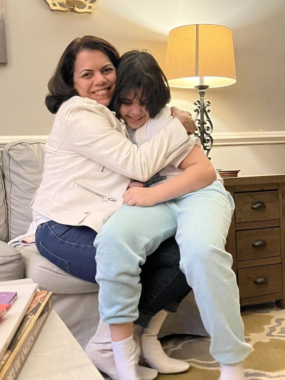 Camille Mojica Rey hugs her 9-year-old son Leon, who is transgender. The family moved to Maryland last year after Texas Republican lawmakers kept pushing anti-LGBTQ legislation. u0022He’s 9 and doing what a 9-year-old should be doing, which is going to school and not worrying about being attacked,u0022 Rey said.