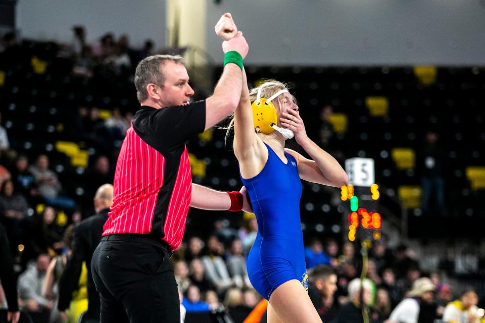 Wilton's Hannah Rogers celebrates after scoring a fall at 120 pounds in the finals during of the Iowa Wrestling Coaches and Officials Association (IWCOA) girls' state wrestling tournament, Saturday, Jan. 22, 2022, at the Xtream Arena in Coralville, Iowa.