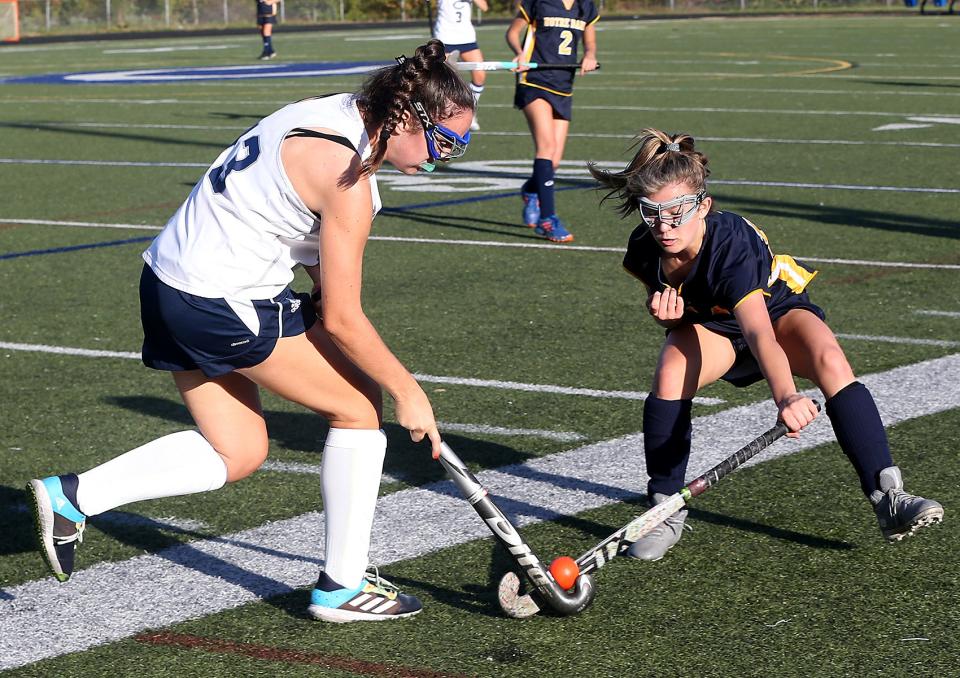 Notre Dame's Emily Coughlin looks to knock the ball away from Cohasset’s Frances Brisbane during second quarter action of their game at Cohasset High on Tuesday, Oct. 12, 2021. 