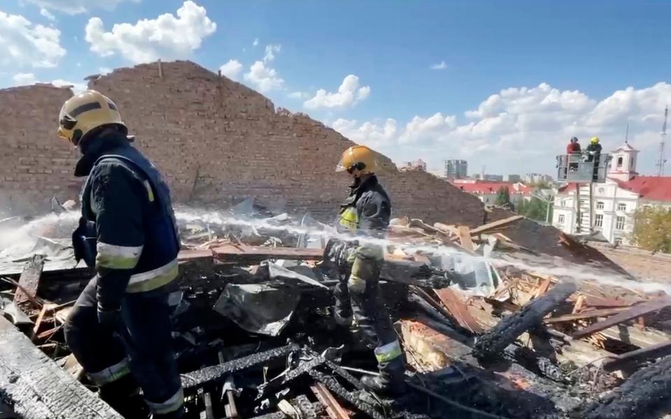 Firefighters work on the roof of the Taras Shevchenko Chernihiv Regional Academic Music and Drama Theatre