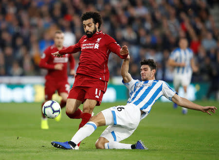 Soccer Football - Premier League - Huddersfield Town v Liverpool - John Smith's Stadium, Huddersfield, Britain - October 20, 2018 Liverpool's Mohamed Salah in action with Huddersfield Town's Christopher Schindler Action Images via Reuters/Carl Recine