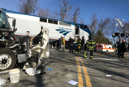 Emergency first responders work at the scene of the crash where an Amtrak passenger train carrying Republican members of the U.S. Congress from Washington to a retreat in West Virginia collided with a garbage truck in Crozet, Virginia, U.S. January 31, 2018. Justin Ide/Crozet Volunteer Fire Department/Handout via REUTERS