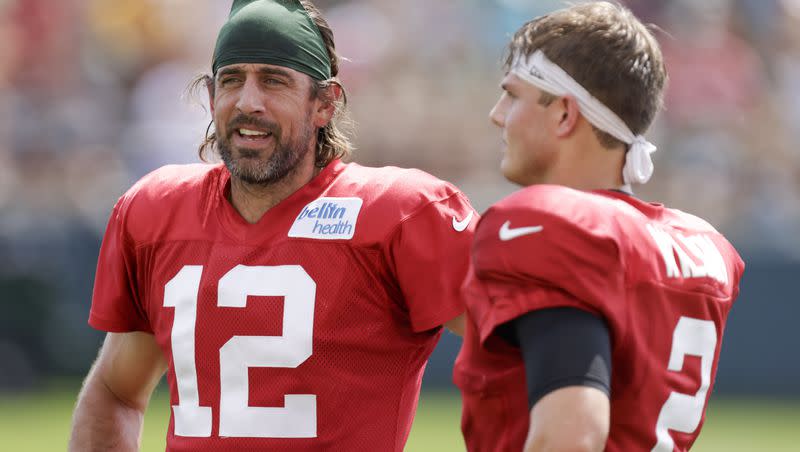 Green Bay Packers quarterback Aaron Rodgers (12) and New York Jets quarterback Zach Wilson (2) talk during a joint NFL football training camp practice Wednesday, Aug. 18, 2021, in Green Bay, Wis. If recent reports are true, Wilson and Rodgers could soon be teammates in New York.