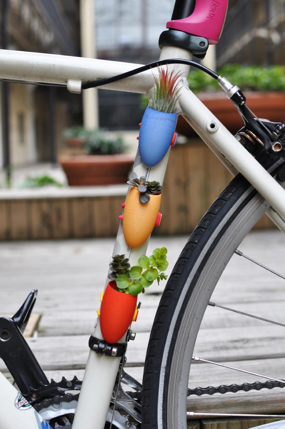 This undated publicity photo provided by Wearable Planter shows small bike-mounted planters created by Colleen Jordan, of Atlanta, using 3D modeling software. Her pieces are printed by a 3D printing service, such as Shapeways or Ponoko. Jordan sells her creations, including diminutive planter necklaces, at her Etsy shop, Wearable Planter. (AP Photo/Wearable Planter, Colleen Jordan)