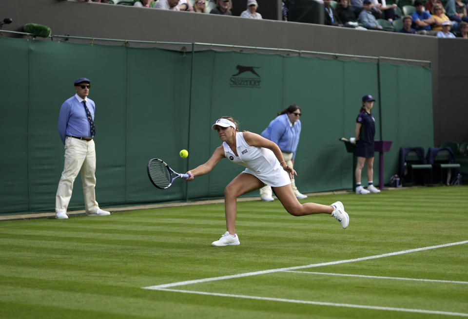 Sofia Kenin of the US returns the ball to China's Xiyu Wang during the women's singles match on day one of the Wimbledon Tennis Championships in London, Monday June 28, 2021. (AP Photo/Alberto Pezzali)