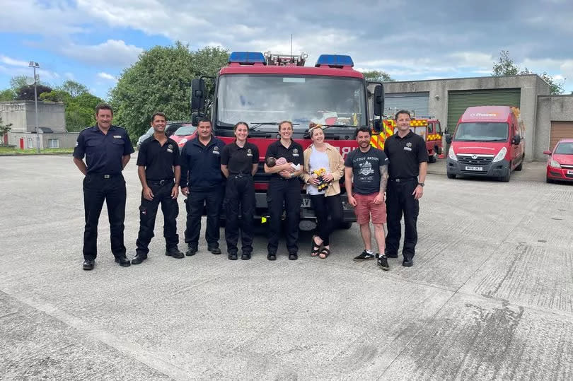 Olive, Alice and Josh with the crews that helped during the delivery