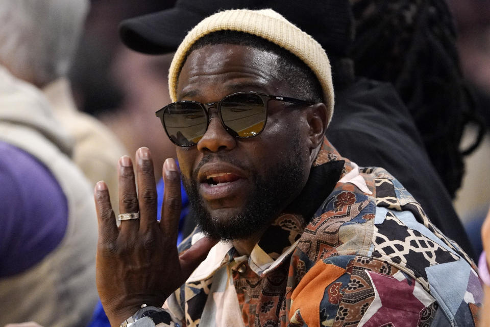 FILE - Comedian Kevin Hart is seen at an NBA basketball game on Oct. 26, 2023, in Los Angeles. Short-term rental giant Airbnb is listing 11 iconic locations, including a one-time evening with comedian Kevin Hart in his members-only lounge, in a splashy new marketing campaign. (AP Photo/Mark J. Terrill, File)