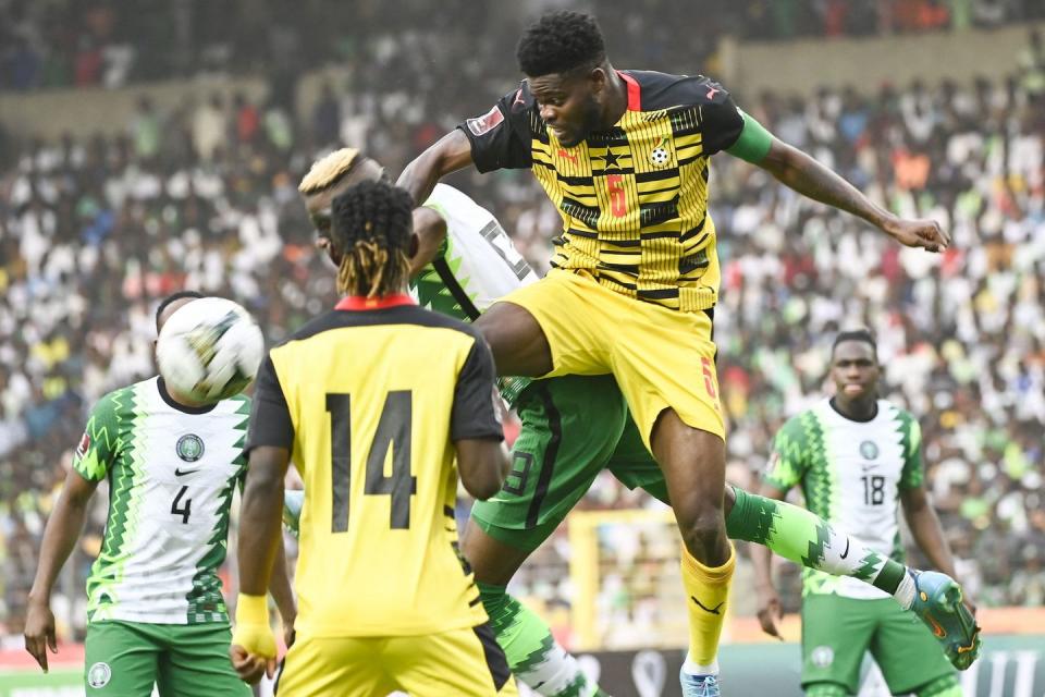 ghana's thomas partey r jumps to kick the ball during the world cup 2022 qualifying football match between nigeria and ghana at the national stadium in abuja on march 29, 2022 photo by pius utomi ekpei  afp photo by pius utomi ekpeiafp via getty images