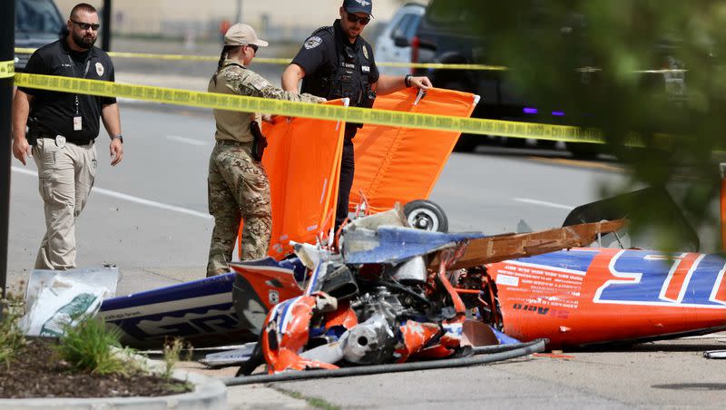 Police investigate the scene where a pilot died in a small plane crash Wednesday, on Copper Hills Parkway between 7800 South and Airport Road, just west of South Valley Airport in West Jordan.