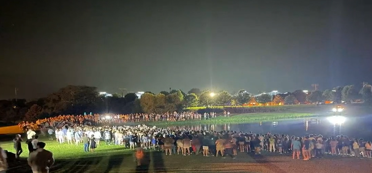 The mass baptism was held around a lake after the Unite Auburn worshipping event (WSFA)