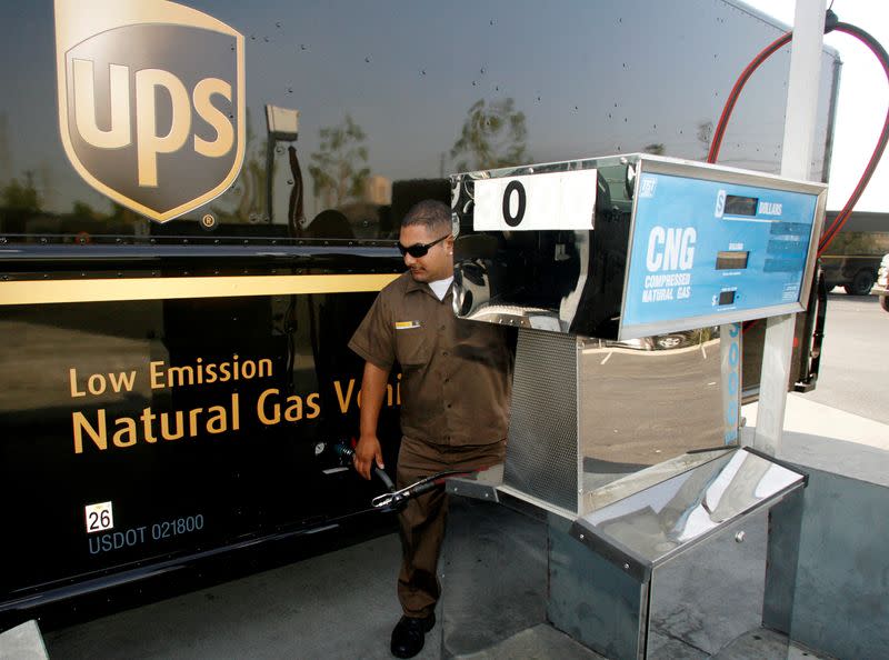 FILE PHOTO: UPS employee Vasquez refuels his vehicle with CNG at a UPS facility in Los Angeles