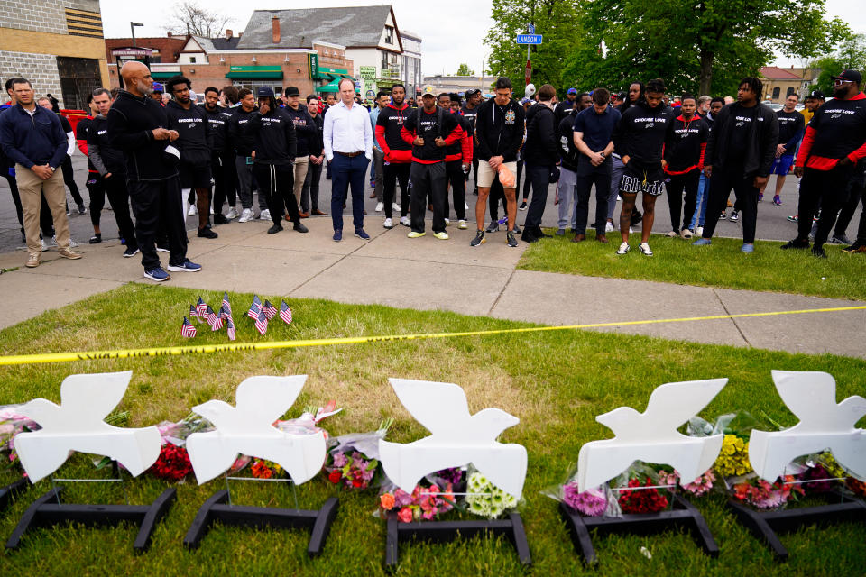 Members of the Buffalo Bills visit the scene of Saturday's shooting at a supermarket, in Buffalo, N.Y., Wednesday, May 18, 2022. (AP Photo/Matt Rourke)