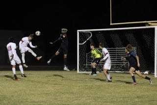 Dwyer defends a header from South Fork in a district semifinal on Jan. 27, 2023 in Palm Beach Gardens.