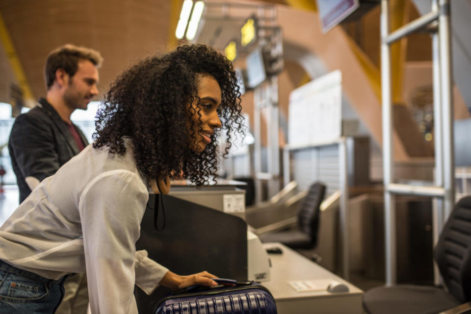 People check-in luggage at the airport