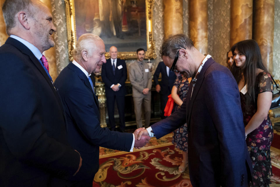Britain's King Charles III greets artist Jonathan Yeo at the unveiling of Yeo's portrait of the King, in the blue drawing room at Buckingham Palace, in London, Tuesday May 14, 2024. The portrait was commissioned in 2020 to celebrate the then Prince of Wales's 50 years as a member of The Drapers' Company in 2022. The artwork depicts the King wearing the uniform of the Welsh Guards, of which he was made Regimental Colonel in 1975. The canvas size - approximately 8.5 by 6.5 feet when framed - was carefully considered to fit within the architecture of Drapers' Hall and the context of the paintings it will eventually hang alongside. (Aaron Chown/Pool Photo via AP)