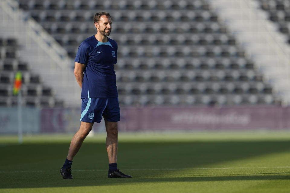 England's head coach Gareth Southgate stands on the field during a training session at Al Wakrah Sports Complex on the eve of the group B World Cup soccer match between England and Wales, in Al Wakarah, Qatar, Monday, Nov. 28, 2022. (AP Photo/Abbie Parr)