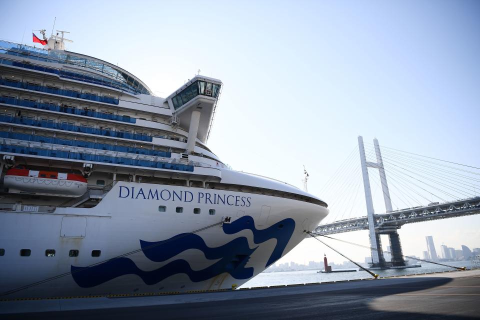 The Diamond Princess cruise ship, with around 3,600 people quarantined onboard due to fears of the new coronavirus, is seen anchored at the Daikoku Pier Cruise Terminal in Yokohama port on February 10, 2020. - Around 60 more people on board the quarantined Diamond Princess cruise ship moored off Japan have been diagnosed with novel coronavirus, the country's national broadcaster said on February 10, raising the number of infected passengers and crew to around 130. (Photo by CHARLY TRIBALLEAU / AFP) (Photo by CHARLY TRIBALLEAU/AFP via Getty Images)