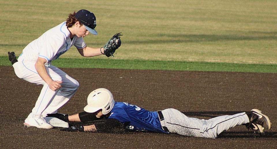 Bartlesville High starting shortstop Zeb Henry , left, doesn't get the ball in time to tag out a Tulsa NOAH baserunner during baseball action March 4 at Bill Doenges Memorial Stadium. Bartlesville won, 13-7.
