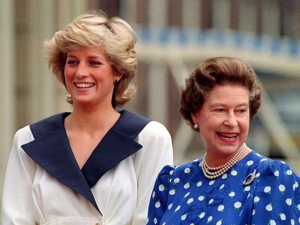 Princess Diana and Queen Elizabeth smile and stand together