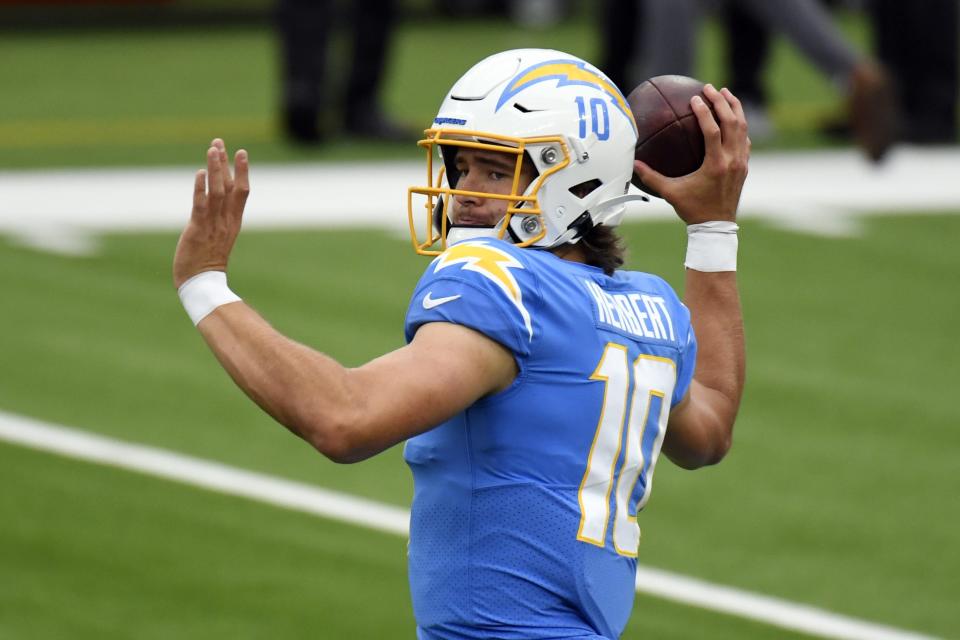 Los Angeles Chargers quarterback Justin Herbert (10) warms up before an NFL football game against the Jacksonville Jaguars Sunday, Oct. 25, 2020, in Inglewood, Calif. (AP Photo/Kyusung Gong)