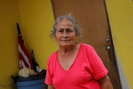 Lydia Perez Molina, a resident affected by Hurricane Maria, poses outside her home in the Trujillo Alto municipality outside San Juan, Puerto Rico, October 9, 2017. REUTERS/Shannon Stapleton