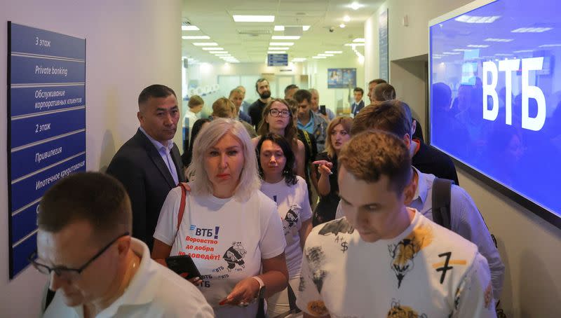 FILE PHOTO: Clients of the Russian bank VTB gather at its head office in Moscow