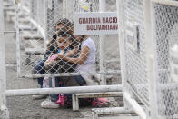 Children wait on the Simon Bolivar International Bridge as they wait for their father to bring their bags as they prepare to cross the bridge from the Cucuta, Colombia to San Antonio, Venezuela, Friday, Aug. 5, 2022, along the partially closed border. The border will gradually reopen after the two nations restore diplomatic ties when Colombia's new president is sworn-in on Aug. 7, according to announcement in late July by Colombia's incoming Foreign Minister Alvaro Leyva and Venezuelan Foreign Minister Carlos Faria. (AP Photo/Matias Delacroix)