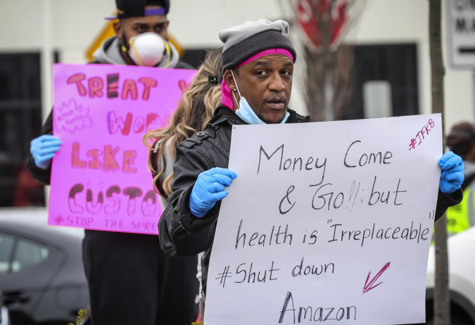 FILE - In this March 30, 2020, file photo, workers at an Amazon fulfillment center in Staten Island, N.Y., protest conditions in the company's warehouse. A month later, even after Amazon scrambled to provide masks and gloves and check employees’ temperatures, Amazon workers have continued scattered walkouts across the country to protest what they say are still-risky conditions in warehouses where workers have had the virus. (AP Photo/Bebeto Matthews, File)