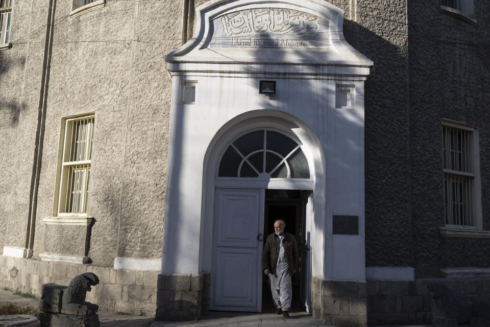 A museum staffer exits the main entrance of the National Museum of Afghanistan, in Kabul, Monday, Dec. 6, 2021. The National Museum of Afghanistan is open once again -- and the Taliban, whose members once smashed their way through the facility, destroying irreplaceable pieces of Afghanistan's national heritage, now appear to be among its most enthusiastic visitors. (AP Photo/Petros Giannakouris)