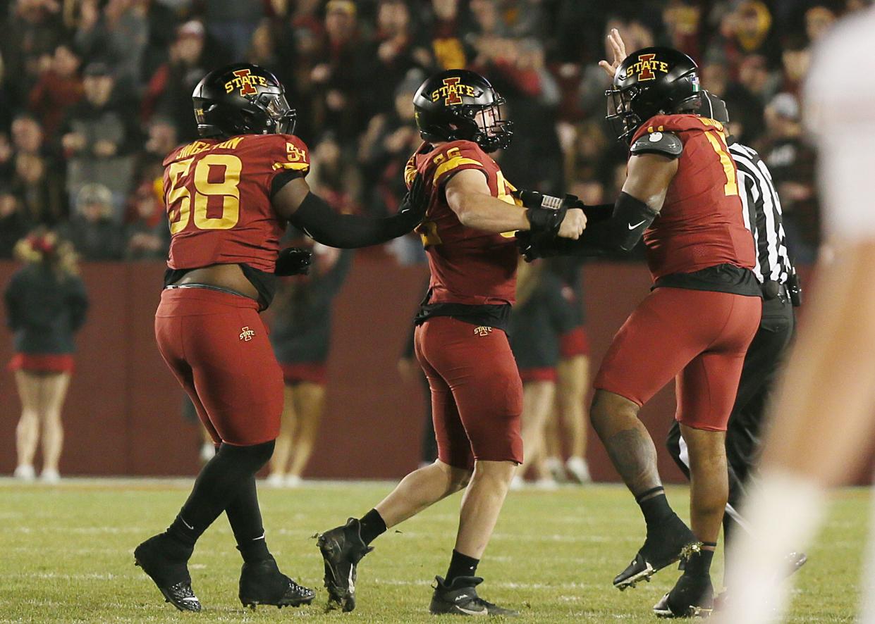 Iowa State linebacker Caleb Bacon (50) celebrates with teammates after a quarterback sack during the first quarter of Saturday's game vs. Texas.