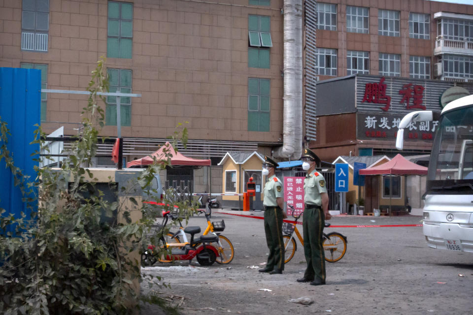 Image: Police at Xinfadi market in Beijing (Mark Schiefelbein / AP)