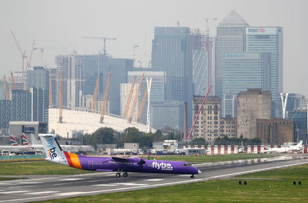 A Flybe Bombardier Dash 8 Q400 airplane taxis at City Airport in London, Britain, September 3, 2018. REUTERS/Hannah McKay