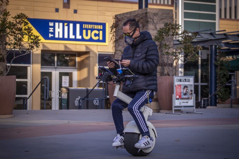 Irvine, CA - January 07: A person rides a one-wheeled scooter amidst a mostly empty University of California-Irvine campus Friday, Jan. 7, 2022. The University of California officials announced the extension of remote instruction on five campuses, stating the high coronavirus positivity rates call for extra precautions at UC campuses. (Allen J. Schaben / Los Angeles Times)