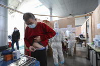 In this Friday, Feb. 21, 2020, photo, a patient injects insulin at a temporary hospital at Tazihu Gymnasium in Wuhan in central China's Hubei province. China's leadership sounded a cautious note Friday about the country's progress in halting the spread of the new virus that has now killed more than 2,200 people, after several days of upbeat messages. (Chinatopix via AP)