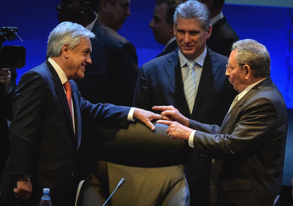 Chile's President Sebastian Pineira, left, talks with Cuba's President Raul Castro, right, while Cuba's Vice President Miguel Diaz-Canel looks on during the final day of the CELAC Summit in Havana, Cuba, Wednesday, Jan. 29, 2014. Leaders from across Latin America and the Caribbean signed a resolution declaring the region a "zone of peace" on Wednesday, pledging to resolve their disputes as respectful neighbors without the use of arms.(AP Photo/Adalberto Roque, Pool)