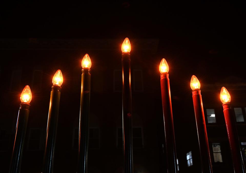 A kinara is lit for Kwanzaa in Salisbury, Md.