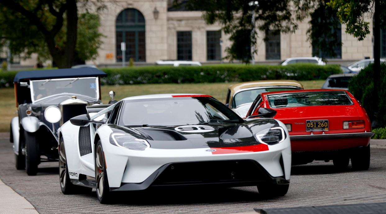 Classic cars parade up and down the circular drive at the Detroit Institute of Arts in Detroit on Thursday, Aug. 2, 2022 after a news conference and preview of the Detroit Concours d'Elegance classic car show happening in September.