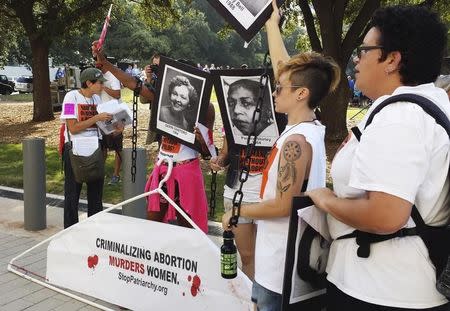 Abortion rights activists protest outside a U.S. federal court in Austin, Texas August 4, 2014 where a hearing started to hear a case by the Center for Reproductive Rights against a new set of restrictions on abortion clinics in the state that go into effect in September. REUTERS/Jon Herskovitz