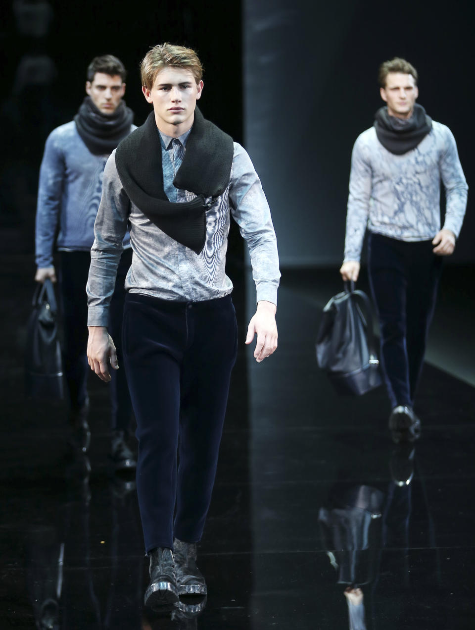 Models wear creations for Emporio Armani men's Fall-Winter 2014 collection, part of the Milan Fashion Week, unveiled in Milan, Italy, Monday, Jan. 13, 2014. (AP Photo/Antonio Calanni)