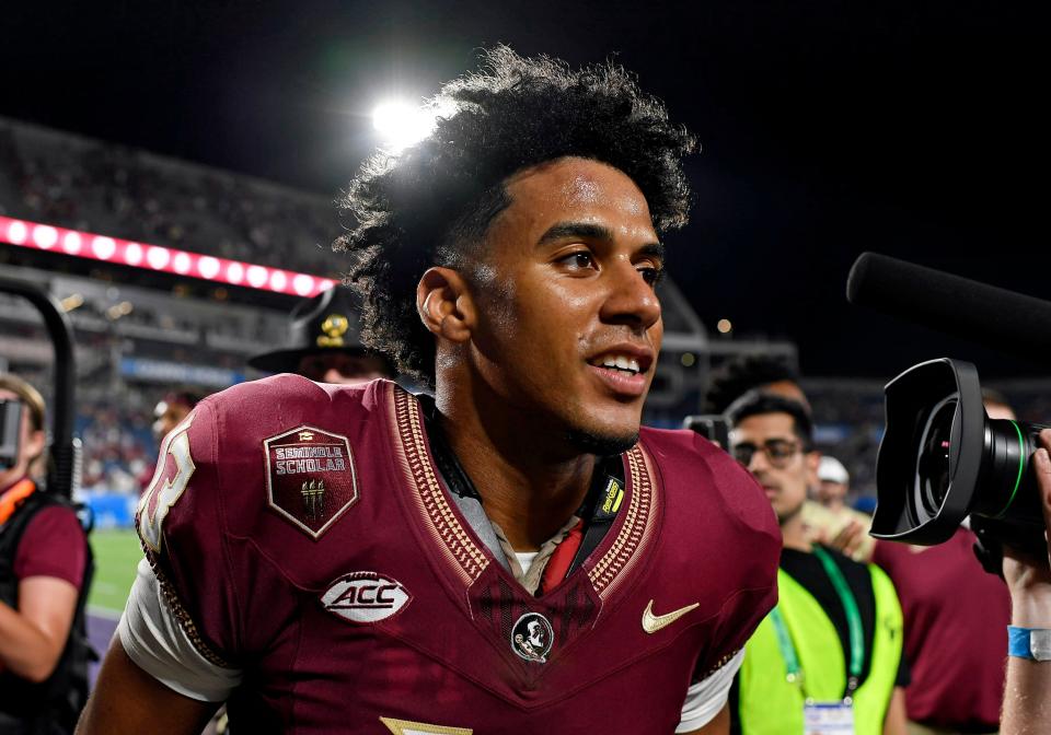 Sep 3, 2023; Orlando, Florida, USA; Florida State Seminoles quarterback Jordan Travis (13) celebrates the win over the Louisiana State Tigers at Camping World Stadium. Mandatory Credit: Melina Myers-USA TODAY Sports