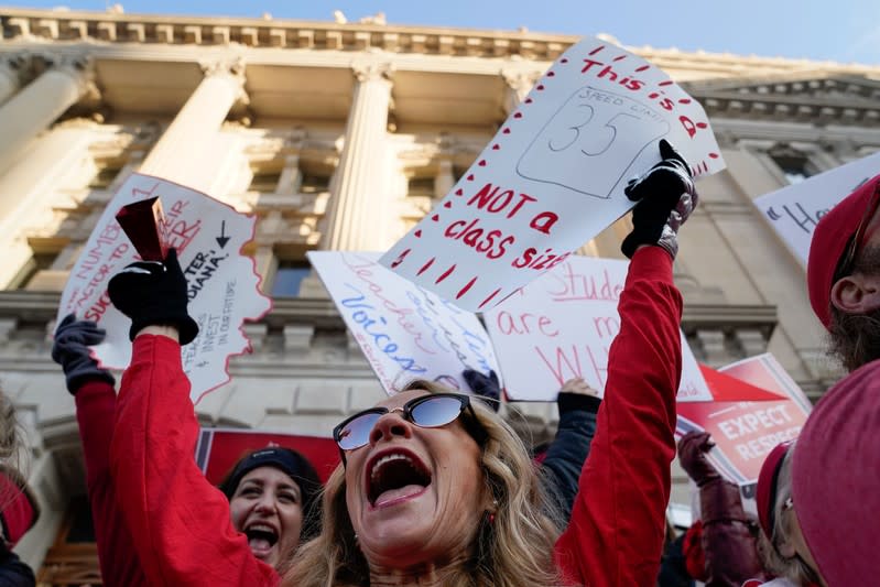 Candy Handy, Chair of the health and physical education department at Central High School in Indianapolis dances on the steps of the Capitol Building as teachers hold a one day walkout at the statehouse in Indianapolis
