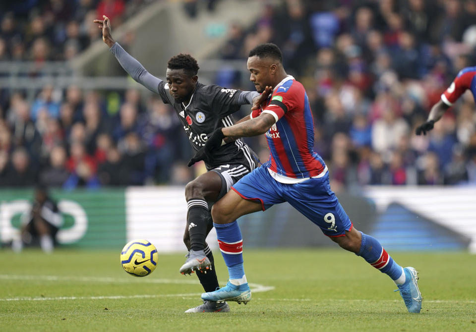 Leicester City's Wilfred Ndidi, left, and Crystal Palace's Jordan Ayew battle for the ball during the English Premier League soccer match at Selhurst Park, London, Sunday Nov. 3, 2019. (John Walton/PA via AP)